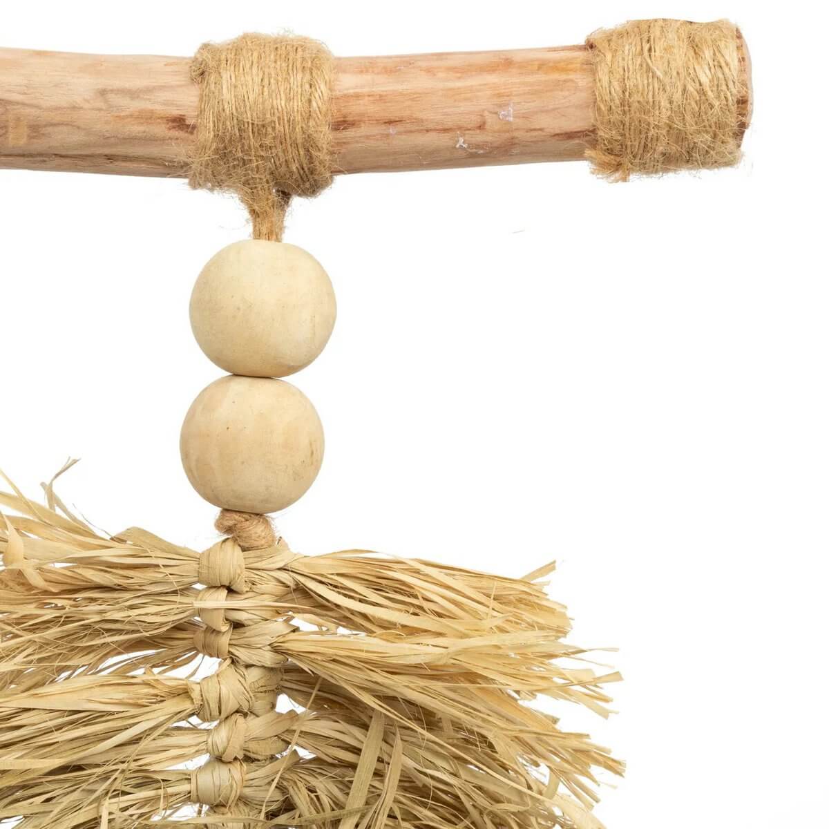 Close-up of handcrafted raffia tassel with wooden beads, creating a Bohemian decor vibe. Perfect for doors, curtains, or walls.