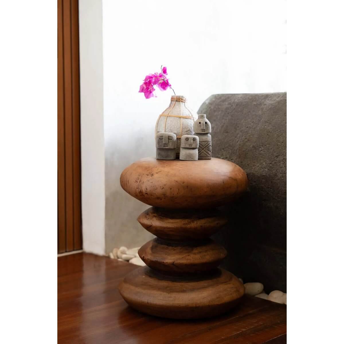 Bohemian-style teak wood stool with decorative vase and stones on top, perfect for indoor or outdoor decor.