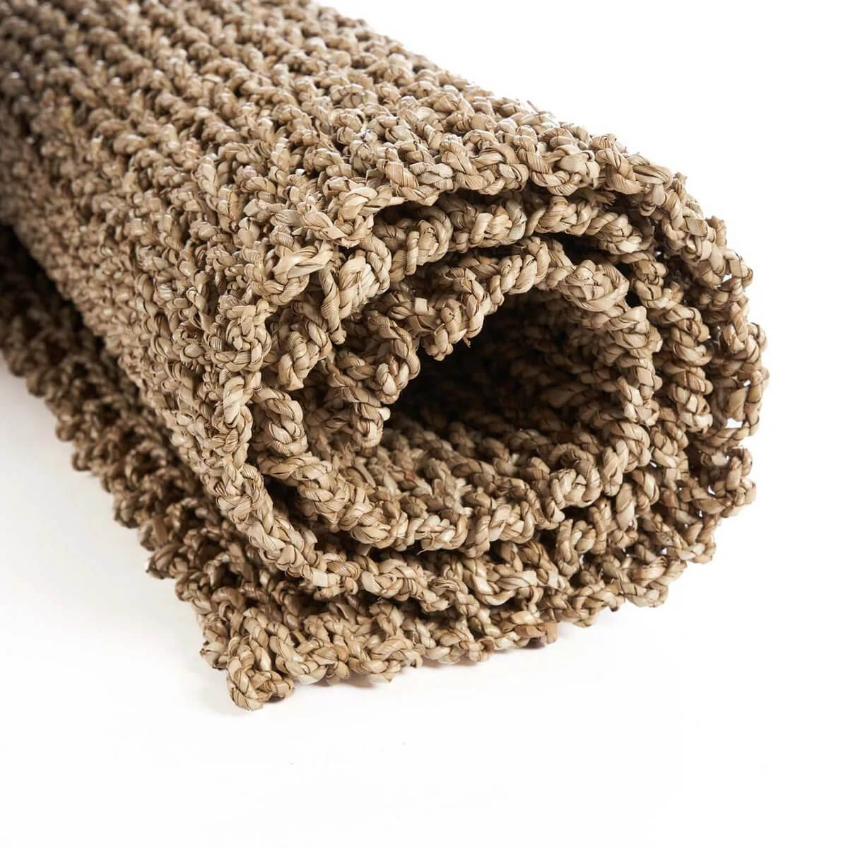 Rolled natural sisal rug with warm earthy tones for a bohemian style home, size 120x70, perfect for any room.