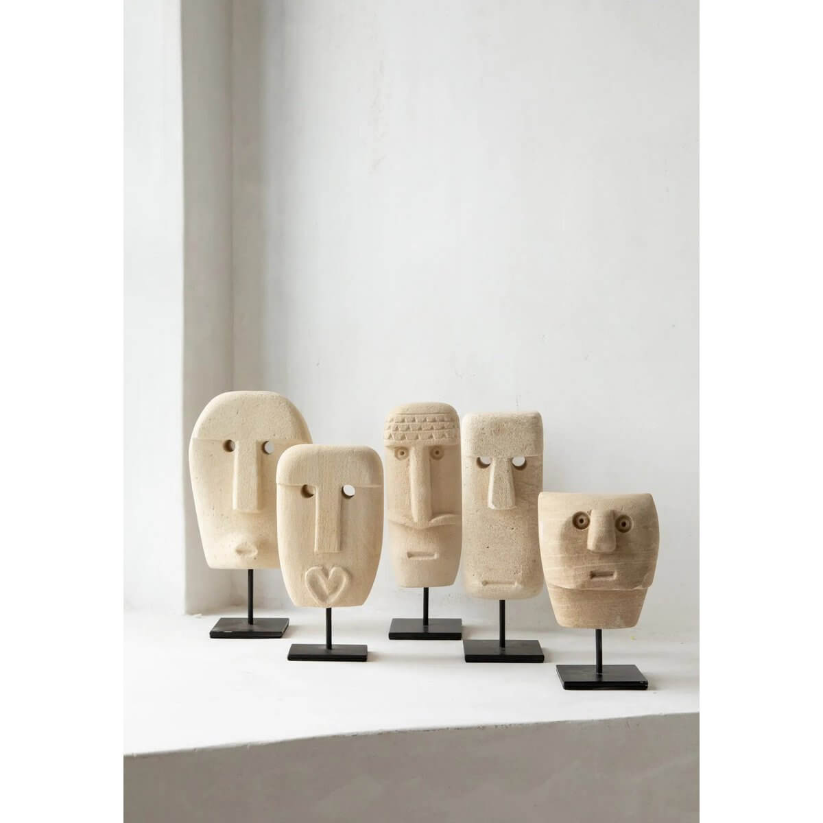 Hand-carved Sumba-stone sculptures on stands, offering Bohemian style and traditional protection from Sumba, Indonesia.
