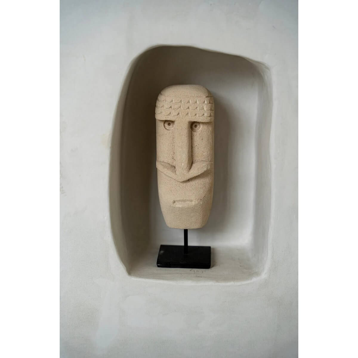 Bohemian Sumba stone statue #21 on a stand, handcrafted from sandstone by local artisans in Indonesia's Sumba Island.