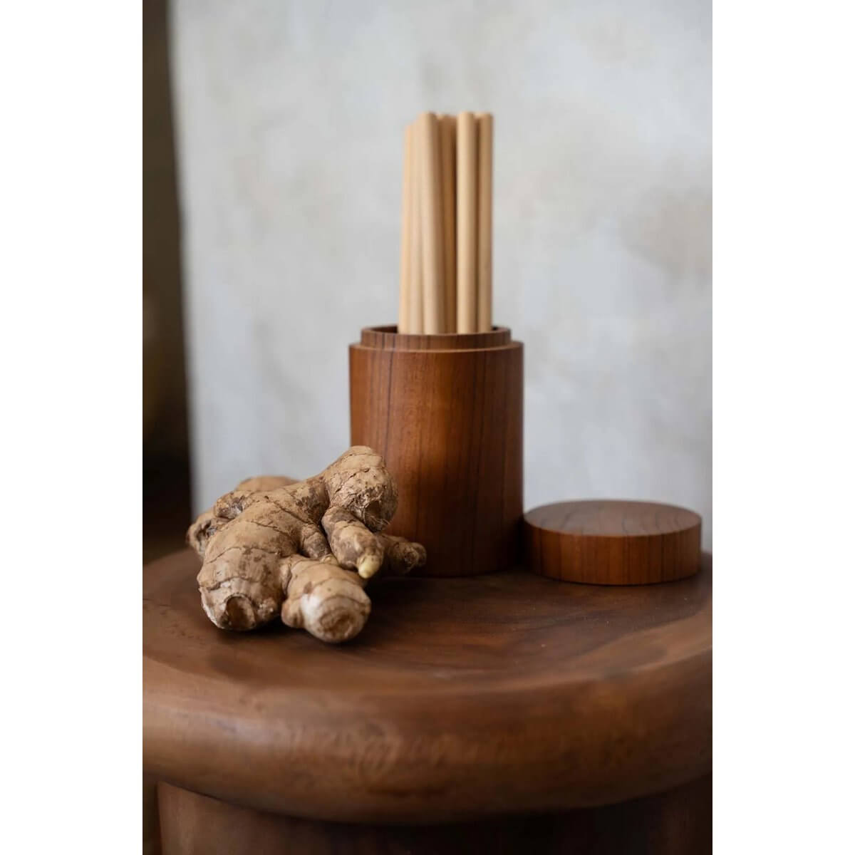 Bohemian teak root jar with intricate textures, showcasing a natural wooden lid and ginger root decoratively placed beside it.