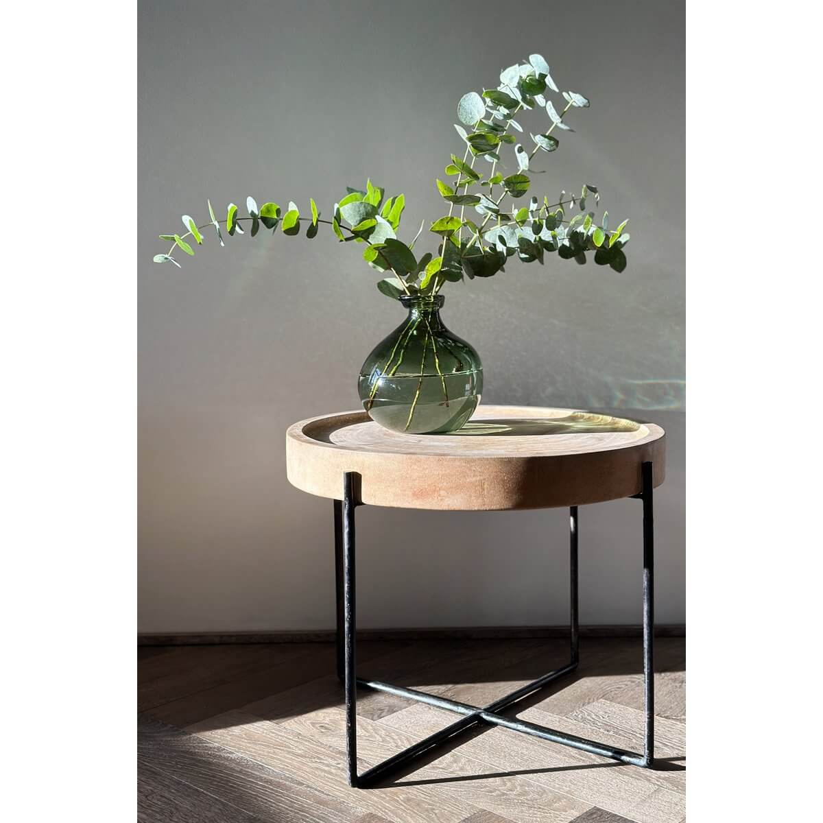 Bohemian style with Xiao Vase in green on round table exudes natural elegance and tranquility with leafy branches.