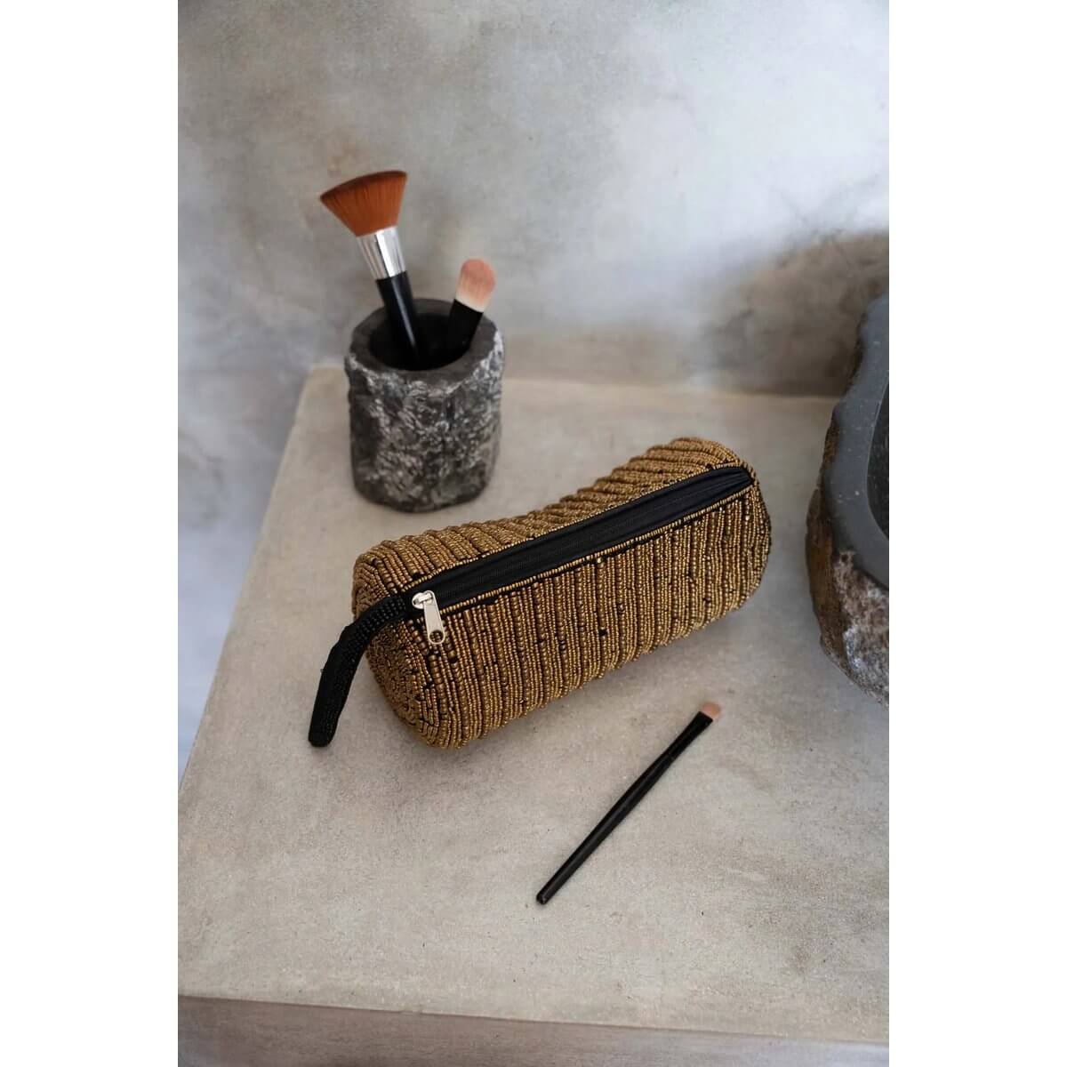 Bohemian gold pencil case on desk with makeup brushes, ideal for organizing pens and makeup essentials in style.