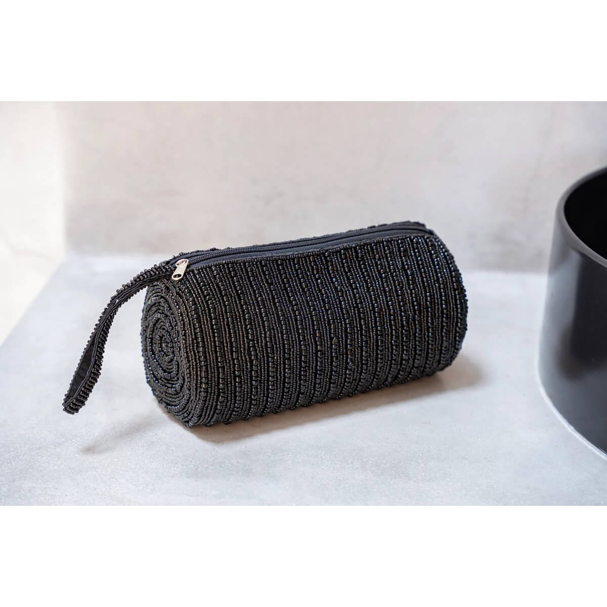 Bohemian black pencil case on desk, perfect for organizing pens, pencils, and makeup essentials. Sleek, multifunctional design.