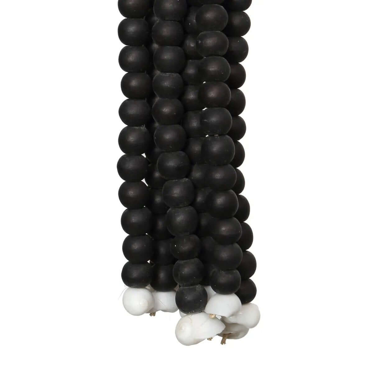 Bohemian black wooden beaded tassel handcrafted by Balinese artisans, perfect for adding an exotic touch to home decor.