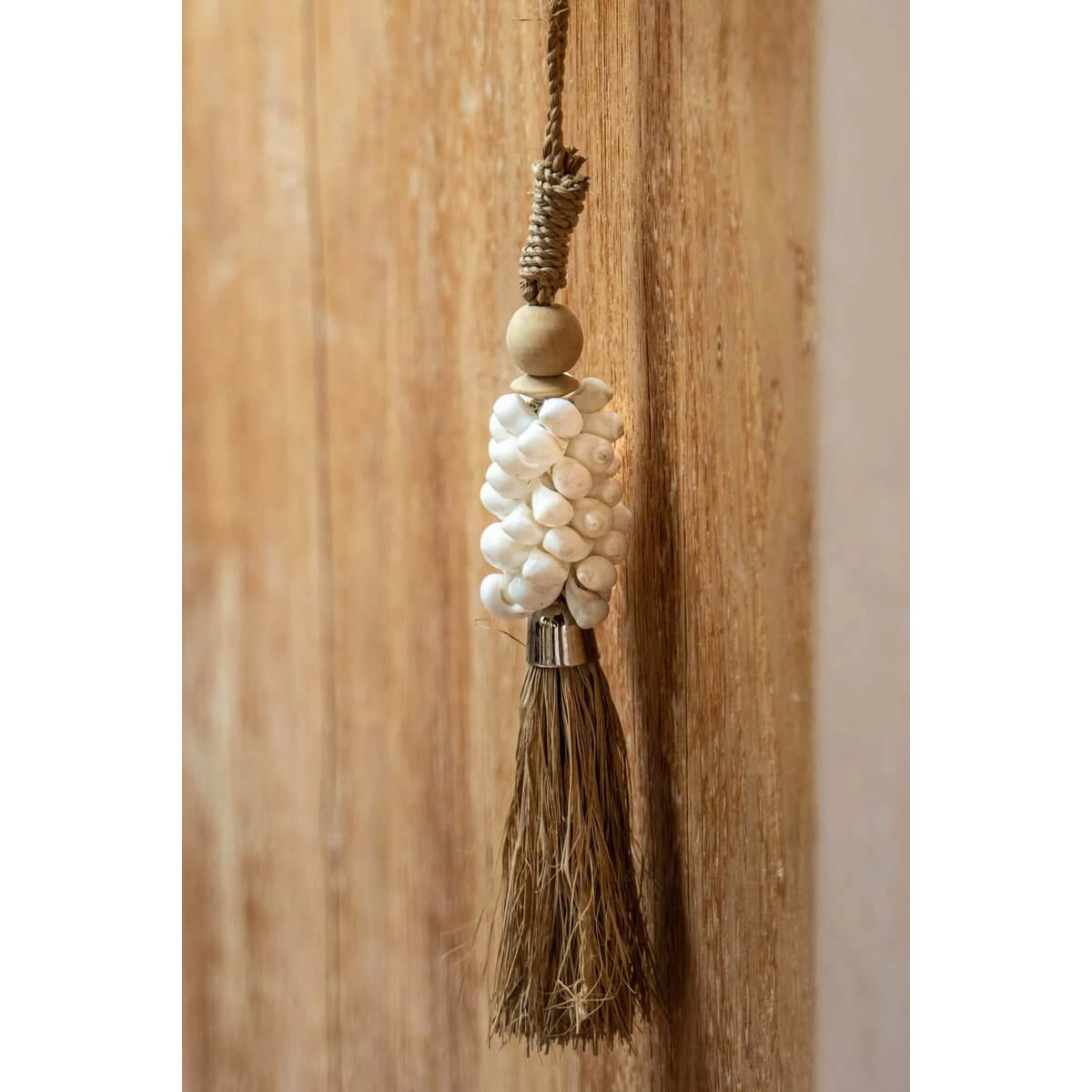 Bohemian Kauri and Raffia Tassel - Handcrafted wall decor by Balinese artisans, adding an exotic touch to your home, by Bazar Bizar Living.