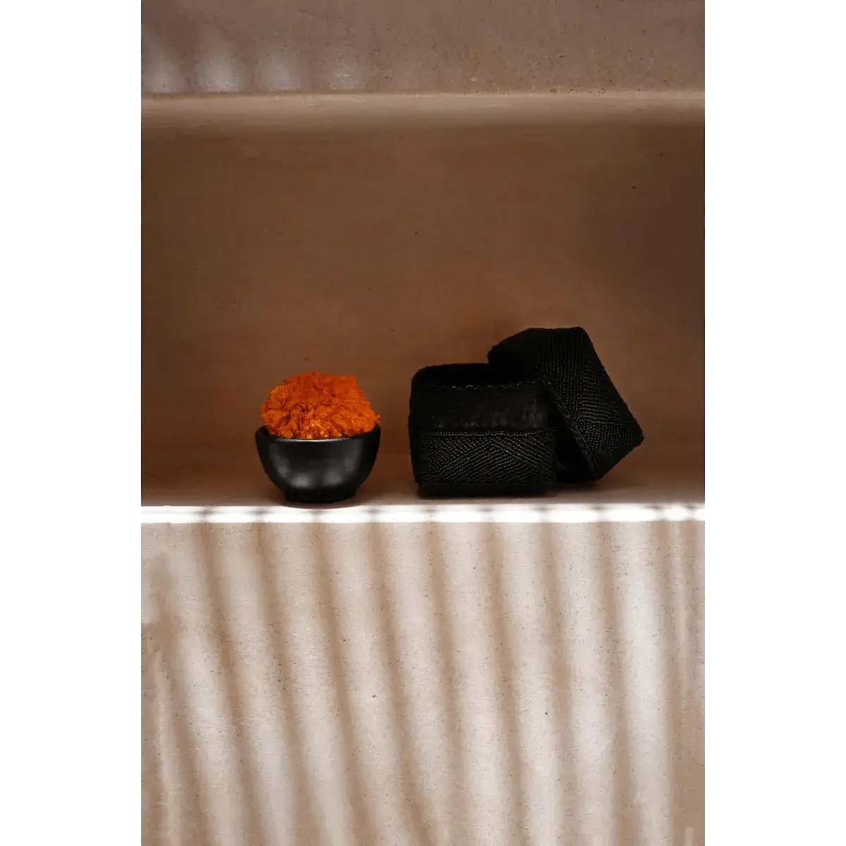 Handmade black bead box and bowl on shelf, crafted by Balinese artisans, adding bohemian flair to your decor.