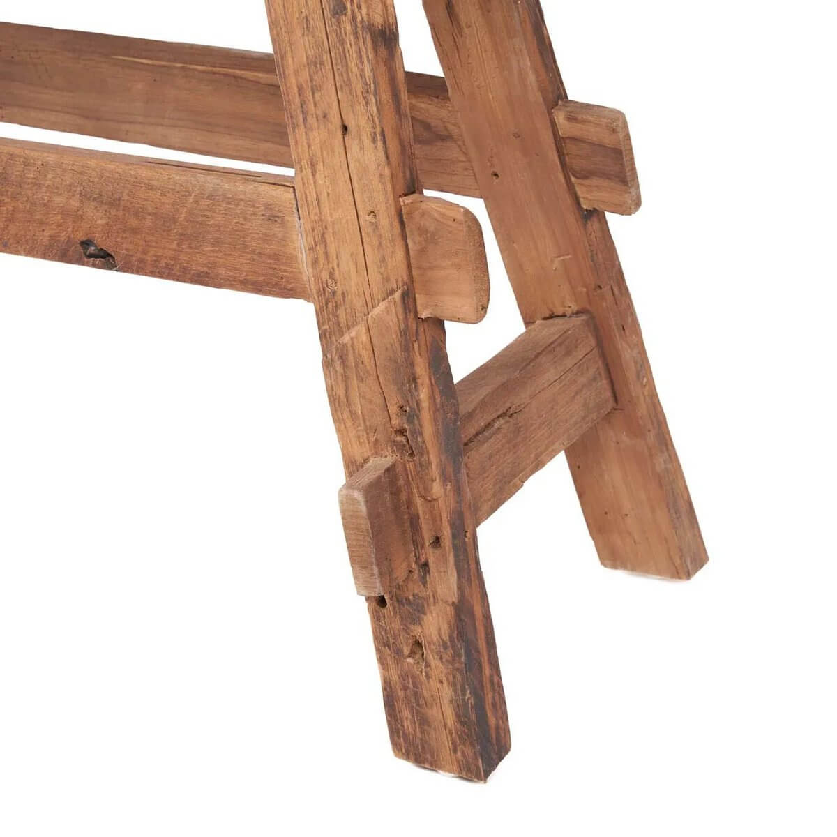 Close-up of a natural wood rustic bench leg showcasing Bohemian design and unique teak woodgrain.
