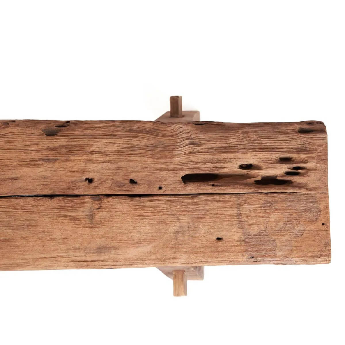 Close-up of the top of a rustic bench with natural wood grain, showcasing unique handmade details and Bohemian style.