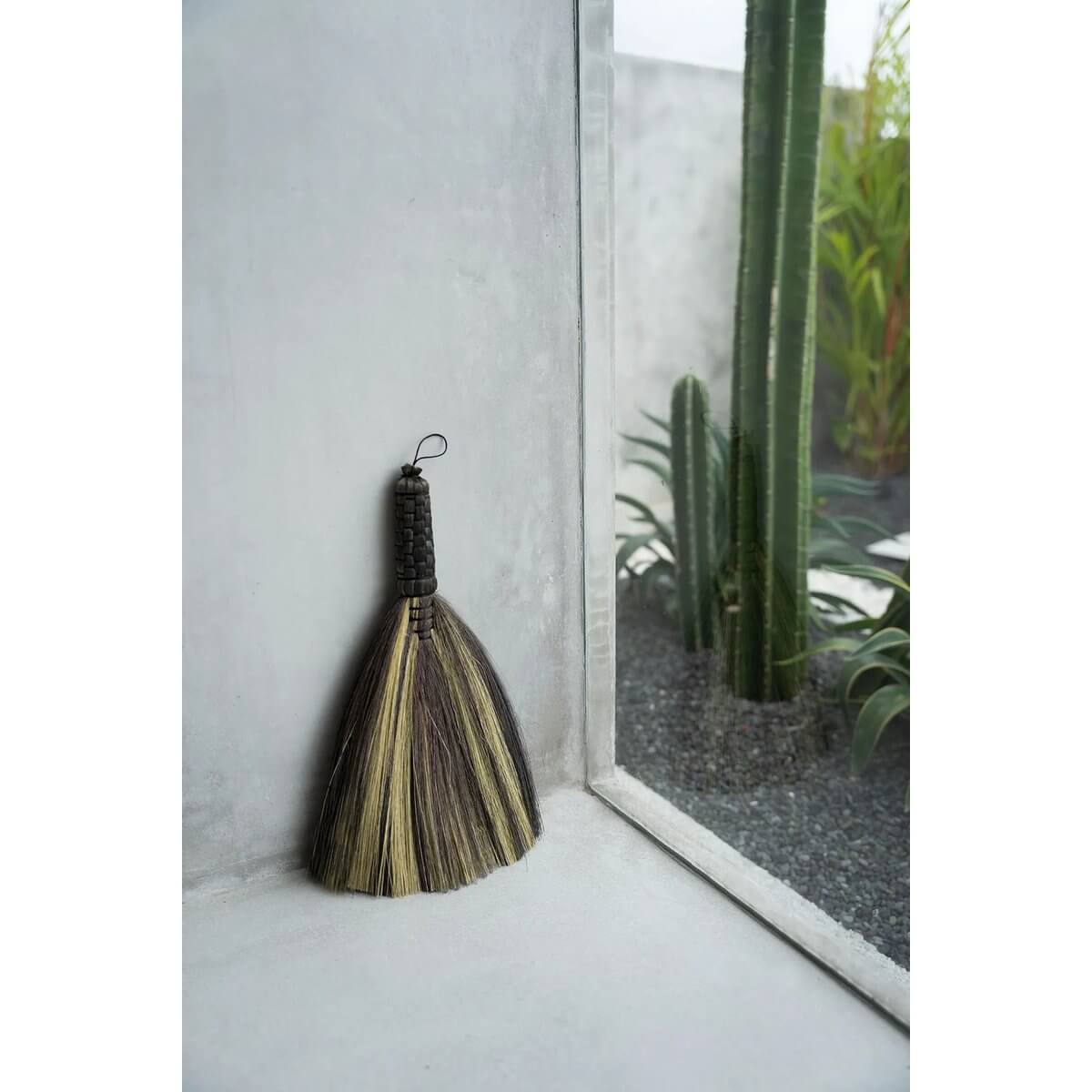 Bohemian black natural hand broom from Indonesia, stylish and functional, perfect for visible indoor or outdoor decor.