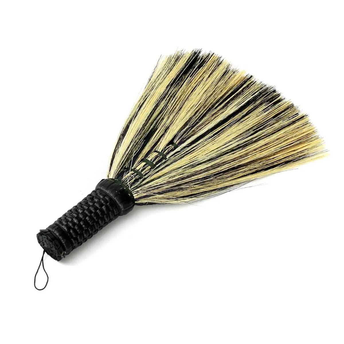 Bohemian black natural hand broom made of grass from Indonesia, perfect for indoor or outdoor rustic decor and cleaning.