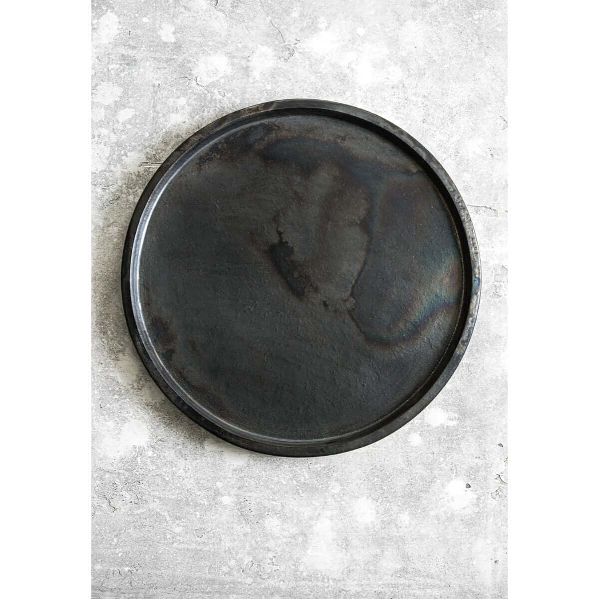 Bohemian style black terracotta plate by Bazar Bizar Living, perfect for chic table settings. Diameter 30cm.