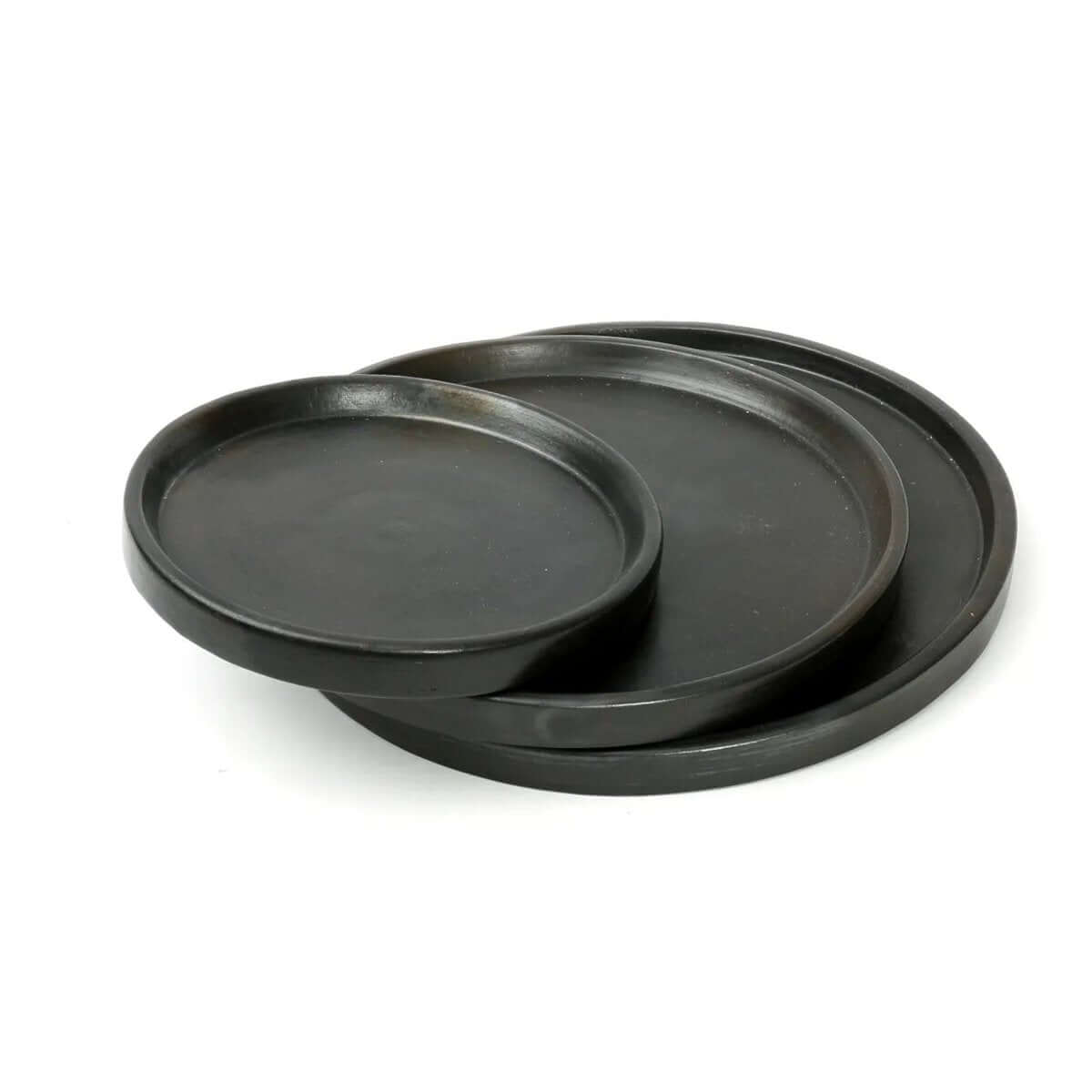 Sleek bohemian black terracotta plates by Bazar Bizar Living, perfect for stylish dining experiences. Diameter 30cm, made of ceramic and earthenware.