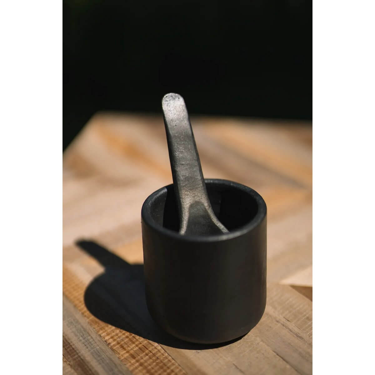 Bohemian style black-burnt tapas spoon in a rustic setting, enhancing colorful dishes with a unique, Instagram-worthy appearance.