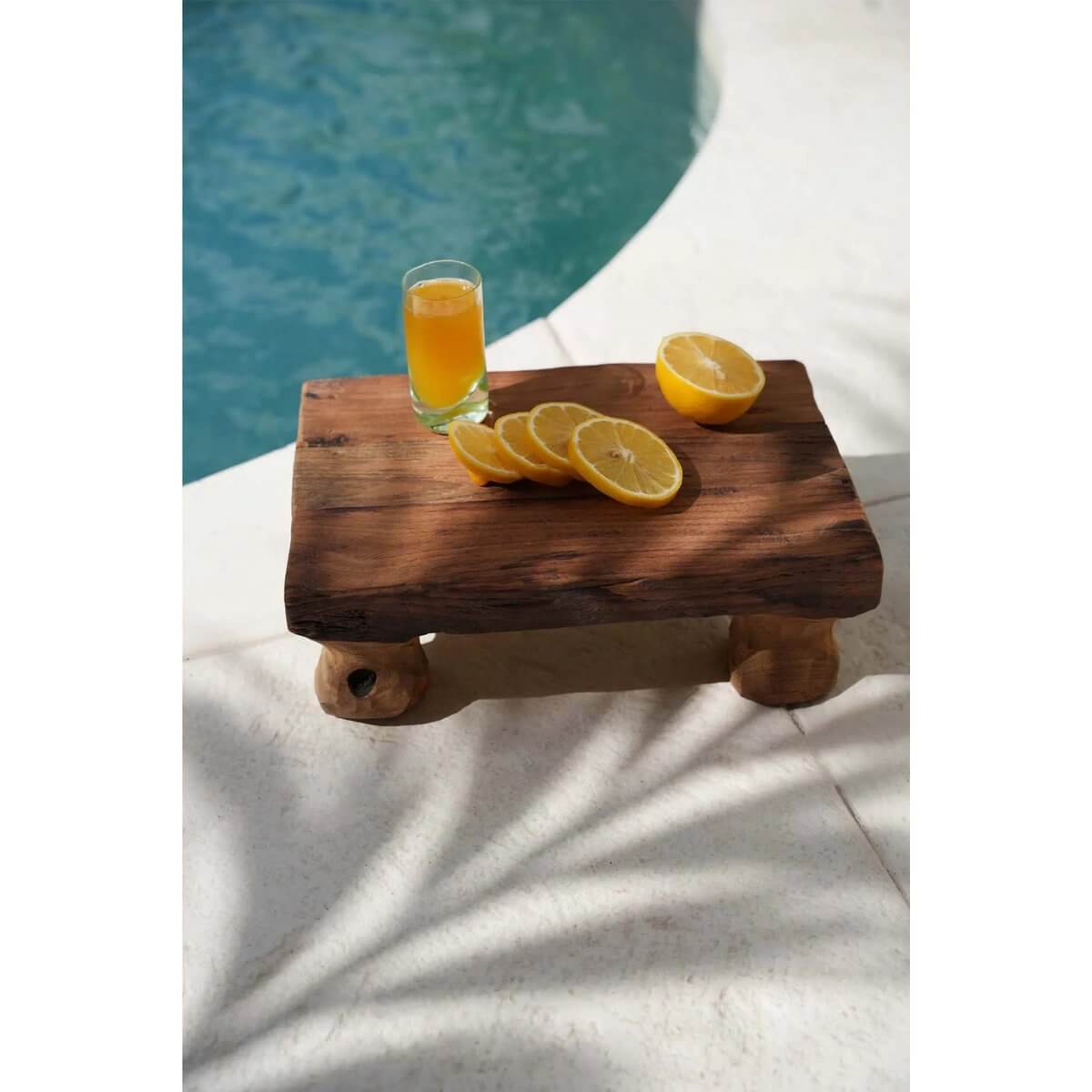 Teakwood snack tray "The Delish Tray" with sliced citrus and juice by the pool. Perfect Bohemian style for entertaining.