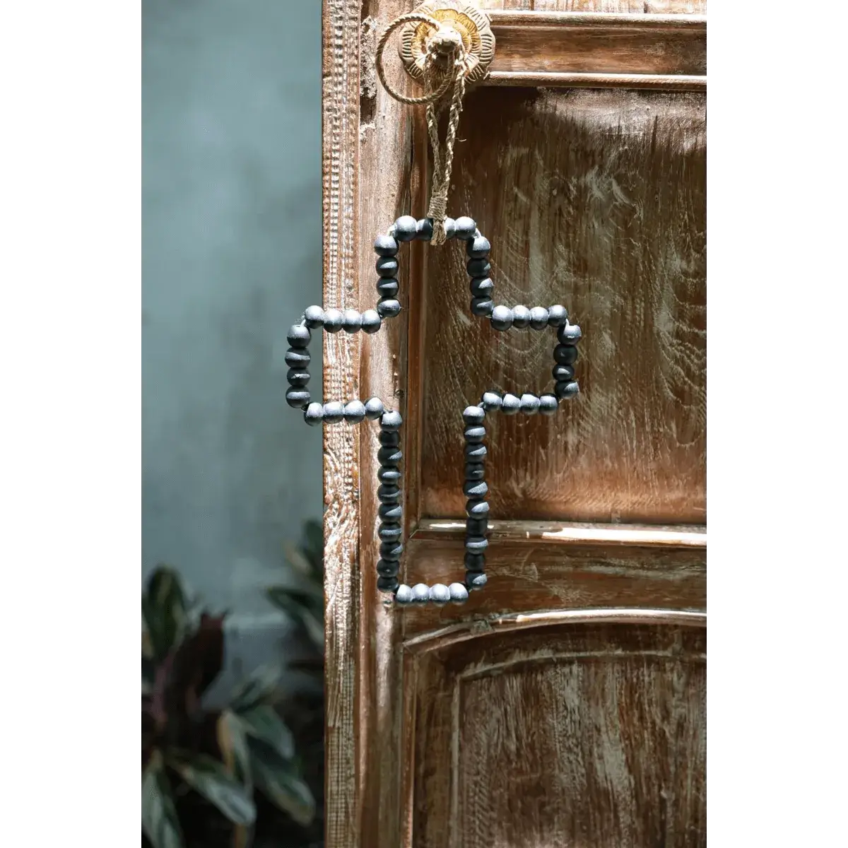 Bohemian black wooden bead cross from Bazar Bizar Living, perfect for eclectic home decor. Handcrafted with elegance and style.