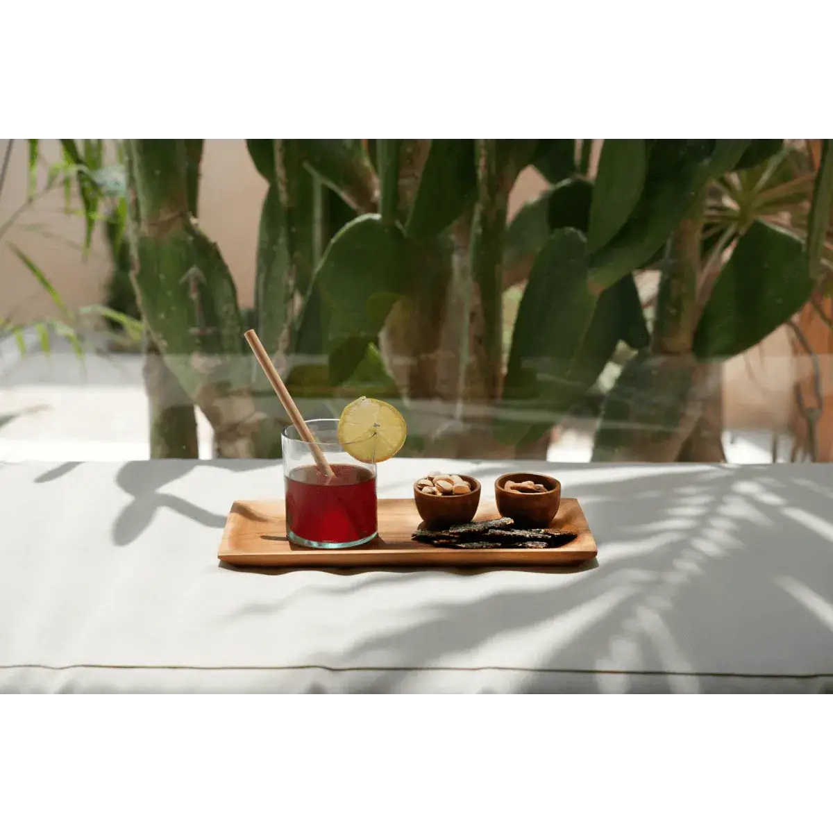 Bohemian breakfast scene with teak egg cups and a drink, set against a leafy backdrop, adding a touch of nature to your morning routine.
