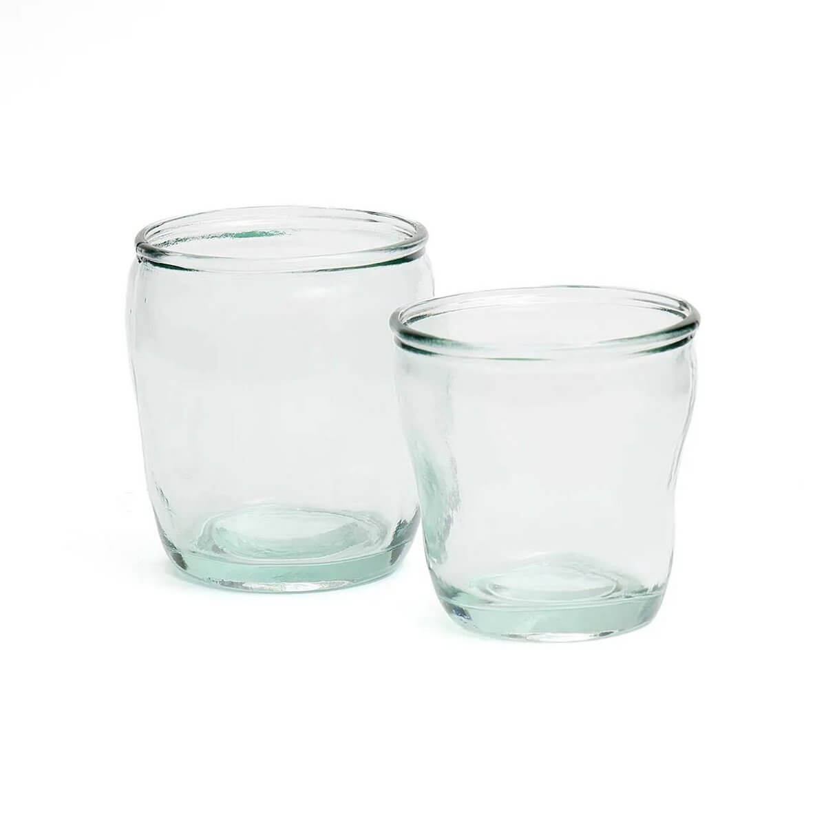 Two elegant Yang Glasses in clear, blue-tinted glass showcasing a Bohemian style for modern eco-friendly gatherings, brand Bazar.