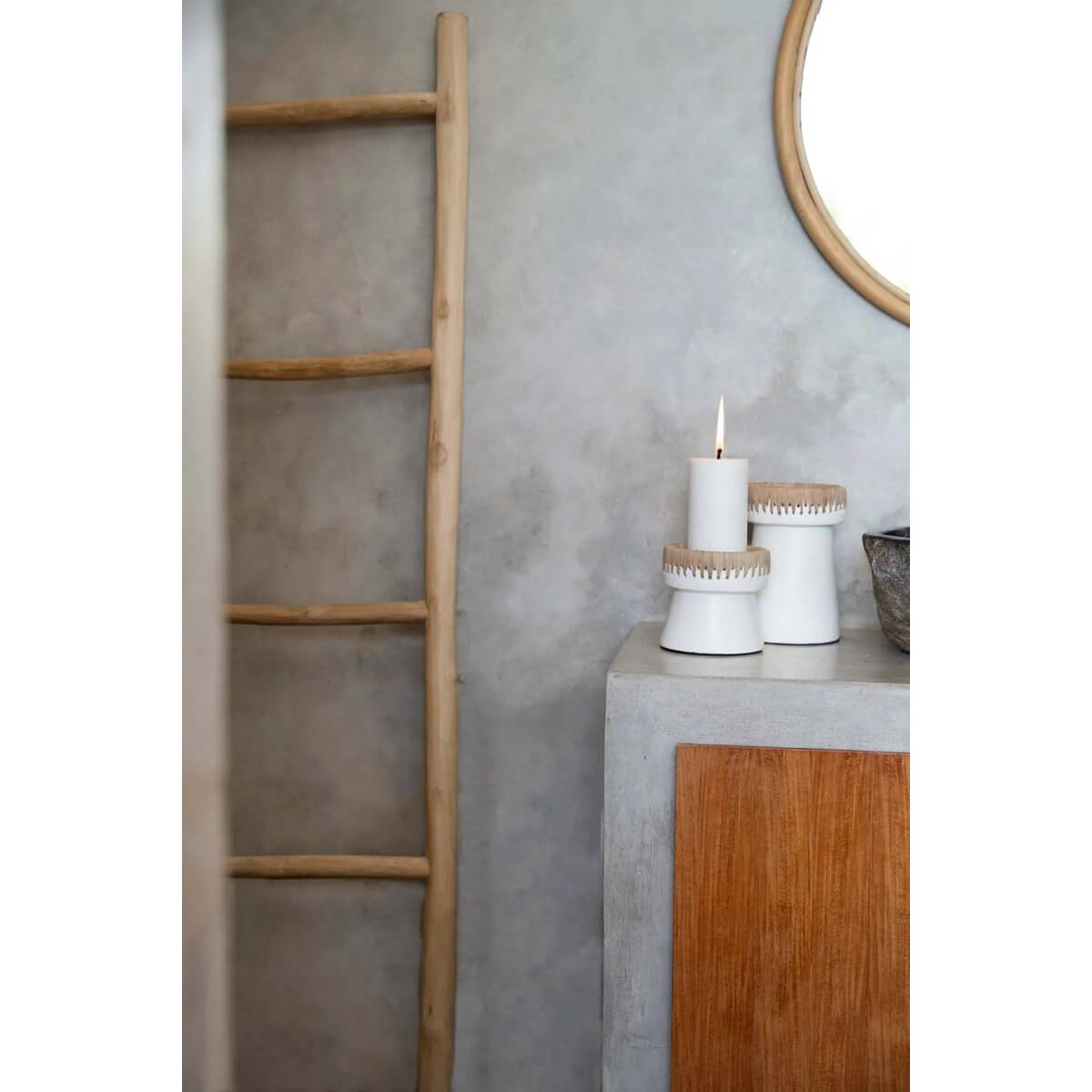 Chic bohemian white terracotta candle holders with raffia accents on a rustic tabletop, adding style and elegance to any decor.