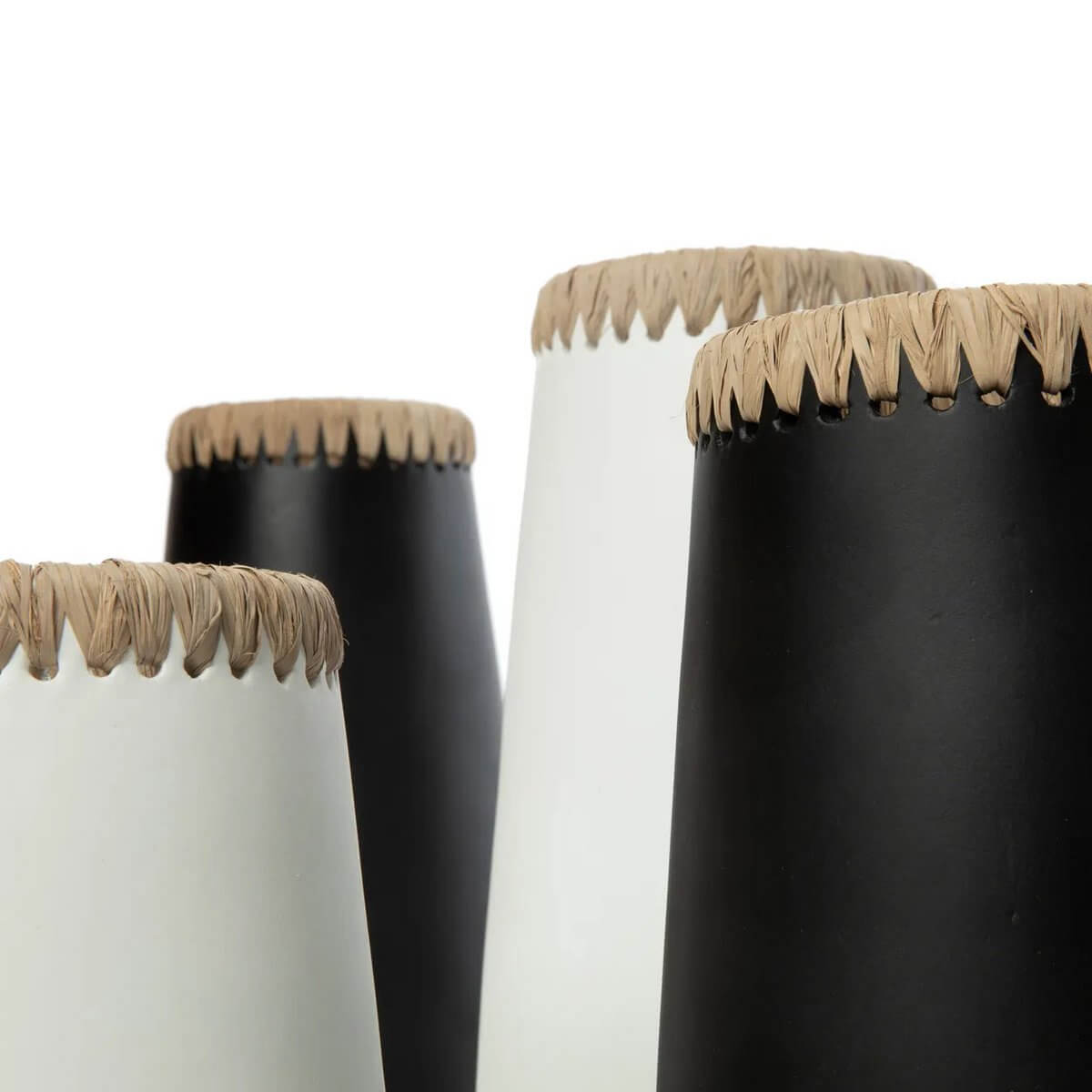Close-up of black and white Sneaky vases with raffia details, perfect Bohemian touch for home decor with dried or fresh flowers.