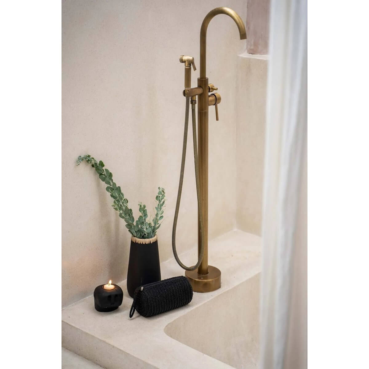 Alt Tag: Bohemian Sneaky Vase with raffia detail near a gold faucet in a modern bathroom, adding charm with fresh greenery and cozy candle.