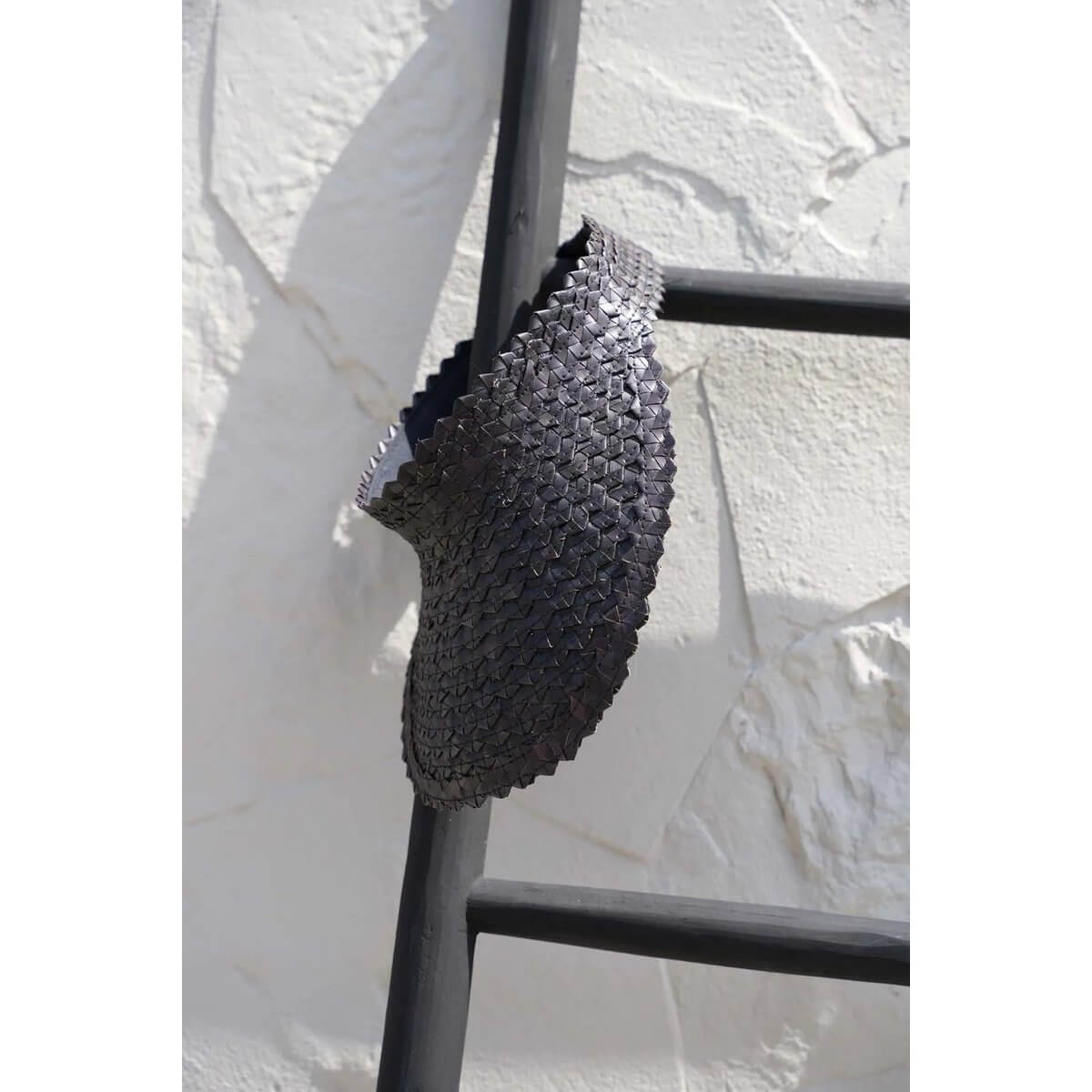 Hand-woven black bamboo sunshade hat on a ladder, perfect bohemian accessory by Bazar Bizar Living for poolside or beach.