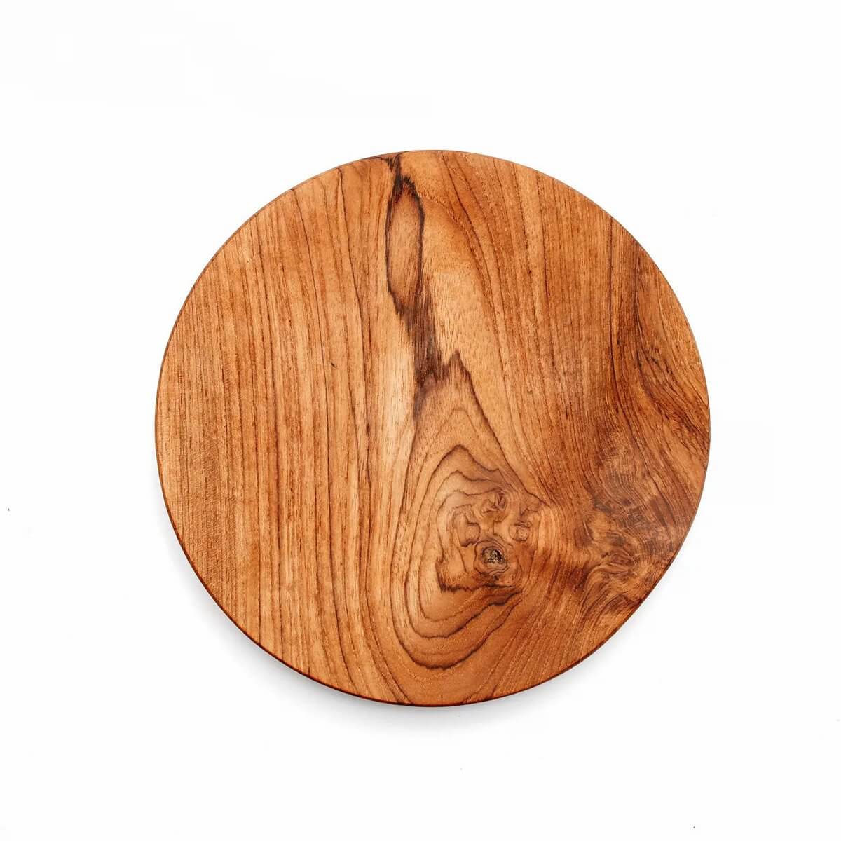 Round teak wood plate with natural patterns, perfect for bohemian-style table setting; multifunctional as a coaster, serving dish, or plate.