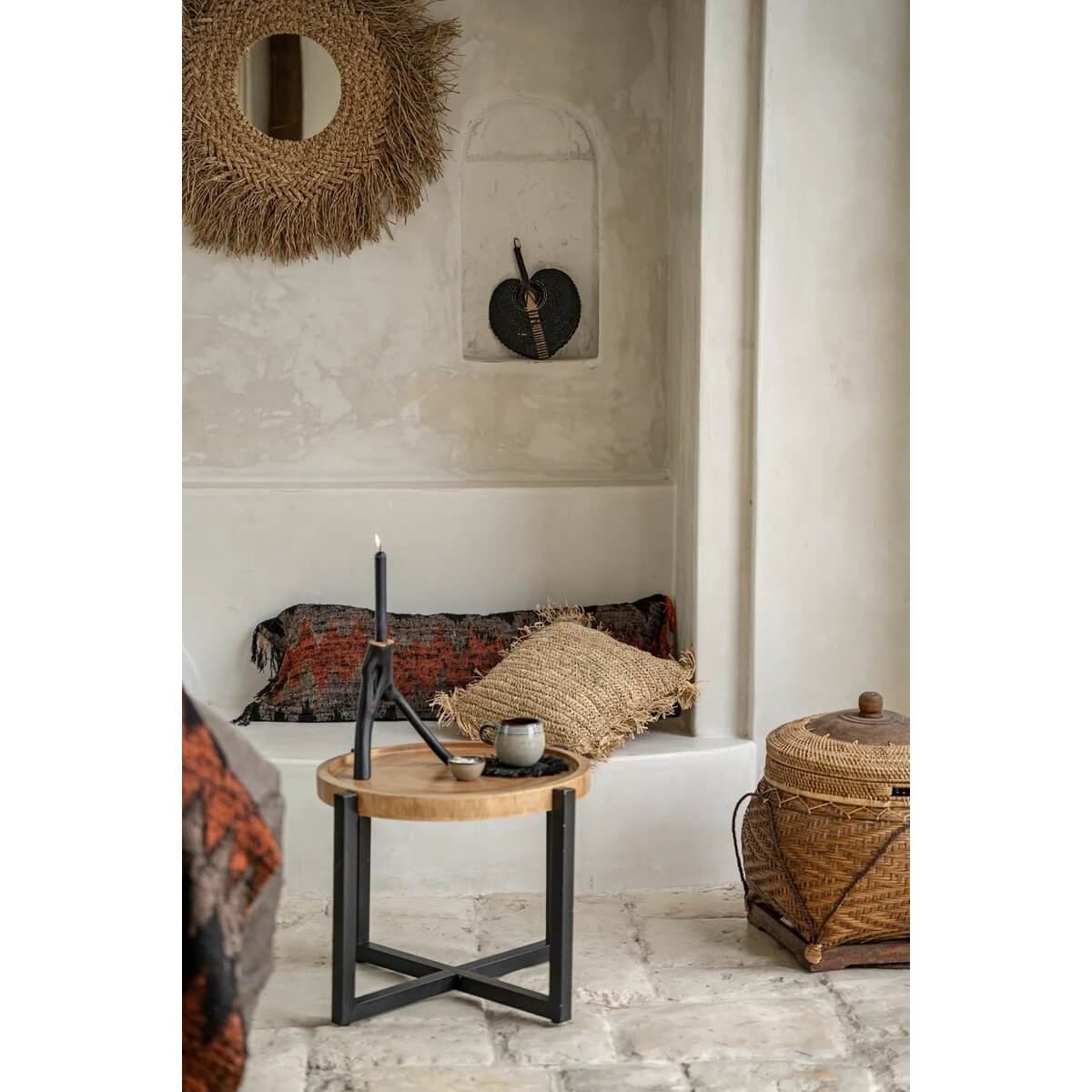 Bohemian style room with a Triple Twig Candle Holder, black metal, on a rustic table, enhancing the cozy interior design.